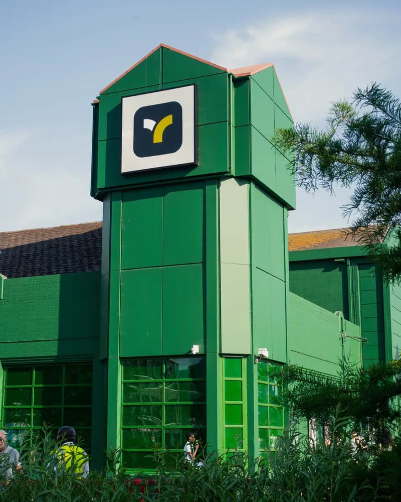 The Teya office building, the logo on its tower against the sky.